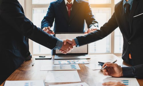 Business people shake hands with business partnership at a meeti